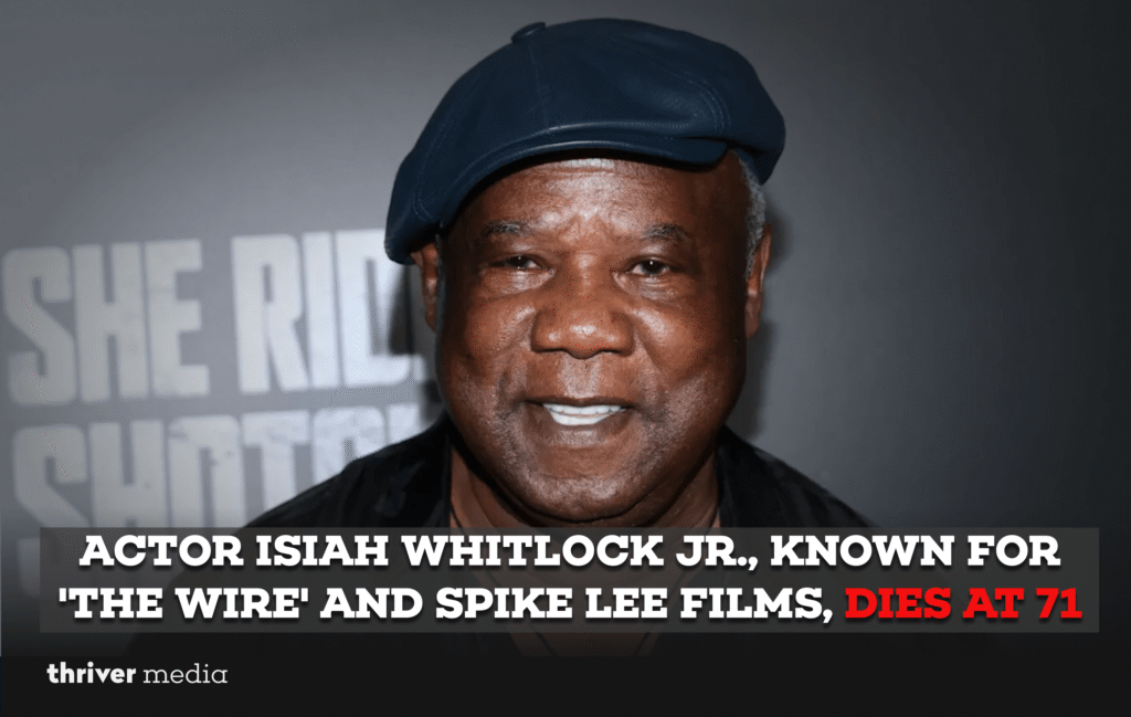 Isiah Whitlock Jr. smiling at a film premiere, wearing a suit and glasses, known for The Wire and Spike Lee movies.