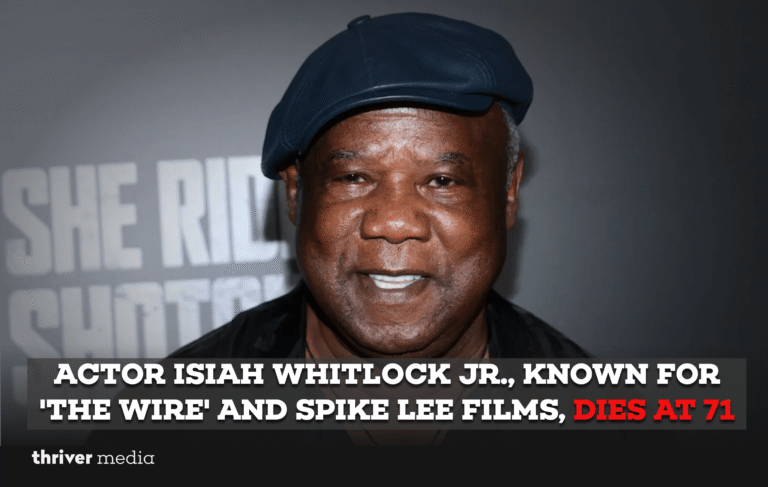 Isiah Whitlock Jr. smiling at a film premiere, wearing a suit and glasses, known for The Wire and Spike Lee movies.
