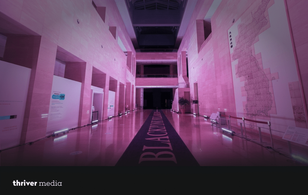 The National Museum of Korea hallway illuminated in pink lighting for BLACKPINK’s DEADLINE collaboration event.