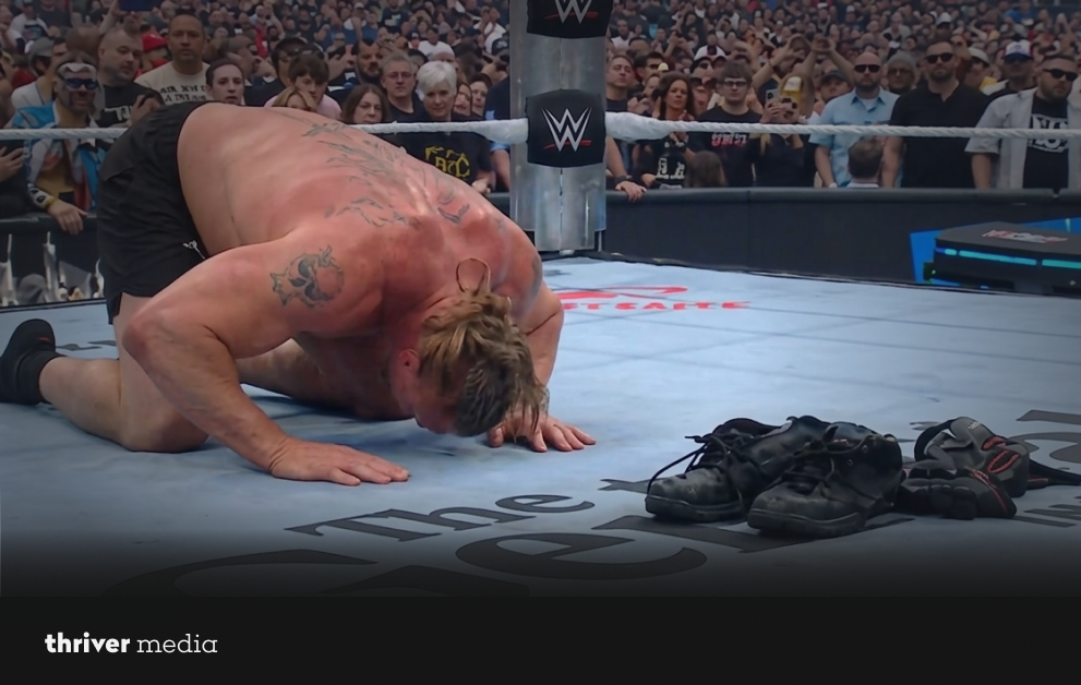 Brock Lesnar kneels in the WWE ring after removing his boots in an emotional moment at WrestleMania
